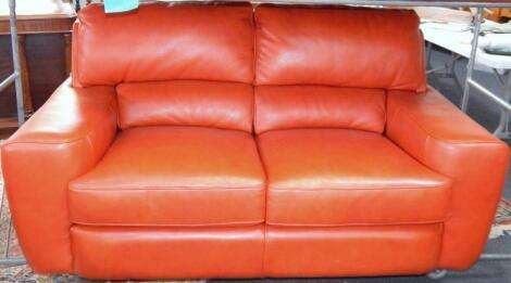 A red hide three seater sofa