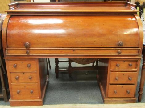 A Victorian mahogany roll top desk