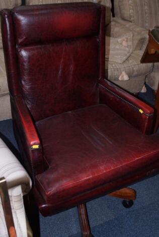 A red leather brass studded office chair