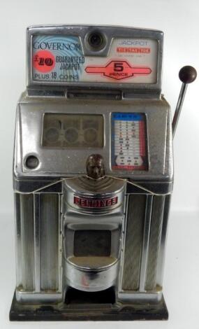 A Jennings white metal and faux wooden cased one arm bandit