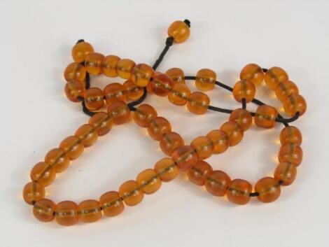 A string of cylindrical amber beads