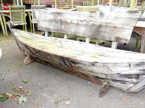 A galley type wooden garden bench