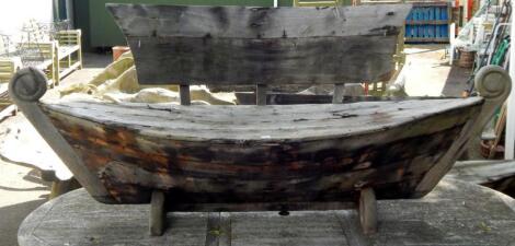 A galley type wooden garden bench