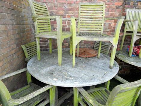 A circular garden table and six carver chairs.