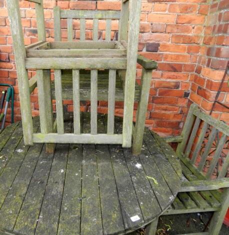 A circular garden table and four carver chairs.