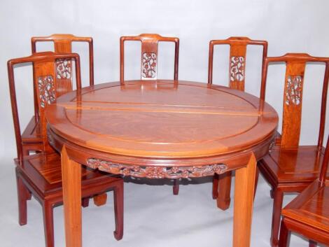 A Chinese hardwood oval draw leaf dining table