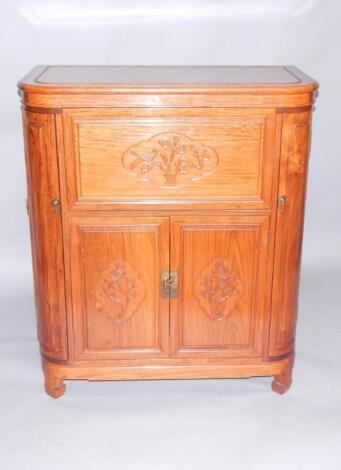 A Chinese bow fronted hardwood cocktail cabinet