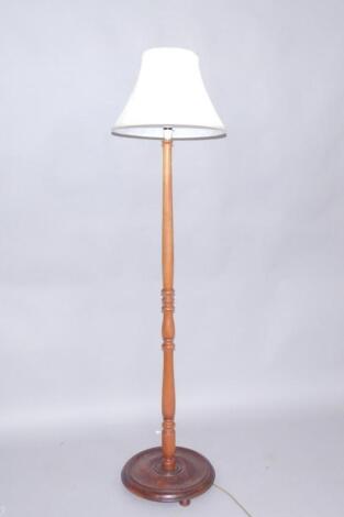 A turned oak standard lamp