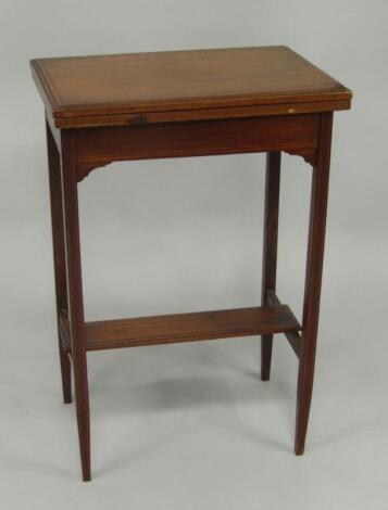 An Edwardian mahogany and boxwood line inlaid rectangular fold over card table