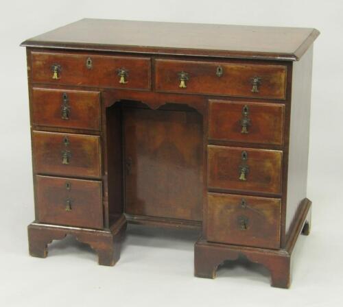 A George II walnut and cross banded kneehole desk