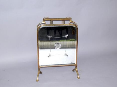 An Art Nouveau brass fire screen