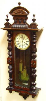 A late 19thC walnut cased Vienna wall clock