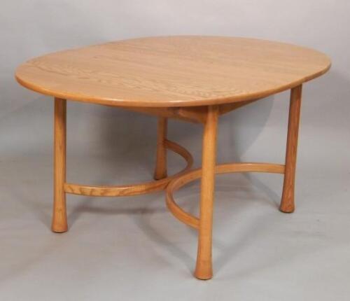 A modern Ercol light elm extending dining table