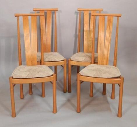 A set of four Ercol light elm reed back dining chairs