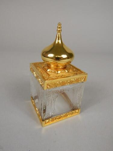 A gilt metal and moulded glass scent bottle