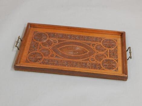 An Indian carved teak tray