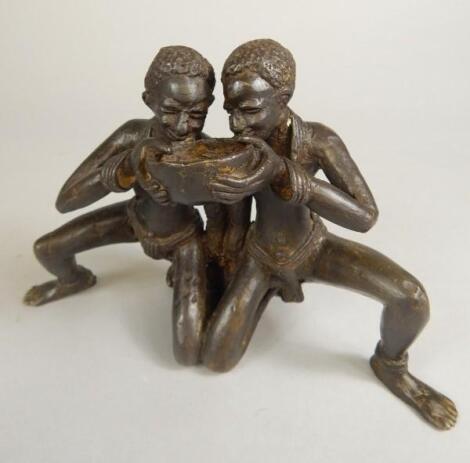 Tribal Art. An African bronze group of two people drinking from a bowl