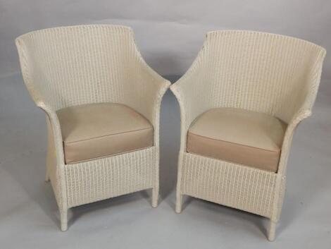 A pair of modern Lloyd Loom of Spalding tub shaped chairs