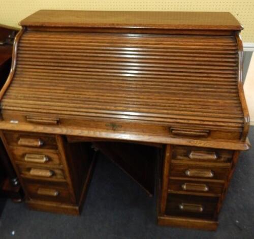 An early 20thC Harris Lebus oak roll top desk