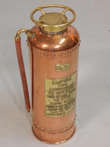 An Empire copper brass and gilt metal fire extinguisher