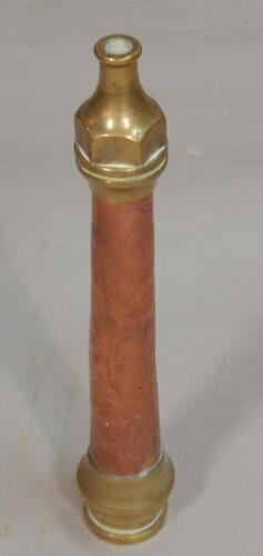 A copper and brass fireman's hose nozzle