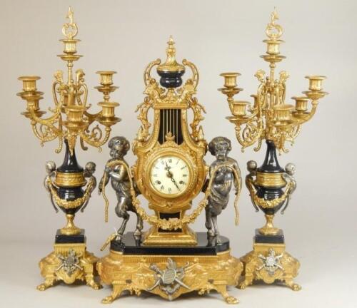 A 20thC French style gilt metal clock garniture