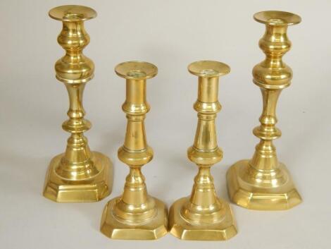 Two pairs of Victorian brass candlesticks