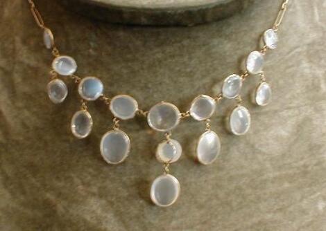 A moonstone necklace, 9 wire set and linked stones, 7 with oval graduated