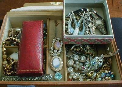 A tan leather covered jewellery box containing a quantity of early 20thC costume jewellery