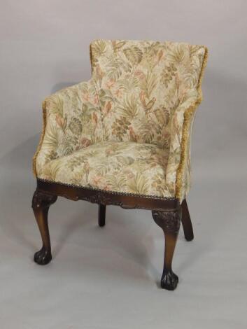 A mid 20thC mahogany tub shaped chair