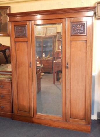 A late Victorian walnut triple wardrobe