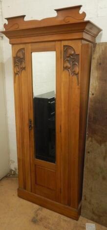 An Art Nouveau satin walnut single mirror door wardrobe