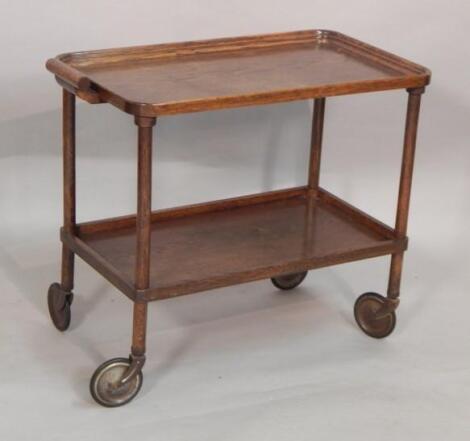 A mid 20thC oak two tier trolley