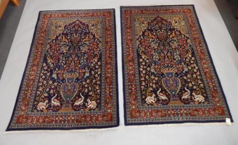 A pair of part silk Persian style rugs