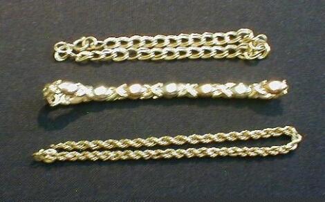 Three yellow metal chain link bracelets