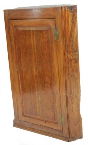 An early 19thC oak hanging corner cupboard