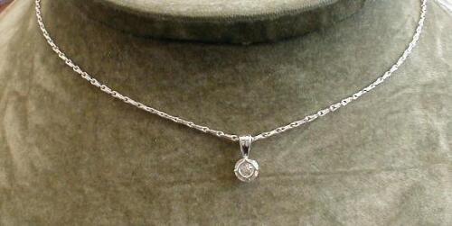 A diamond set pendant; a claw set diamond of 0.56ct stated weight on a fancy link chain