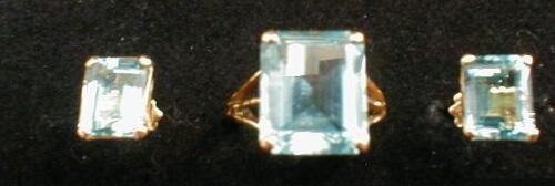 An emerald cut pale turquoise stone set ring (probably aquamarine) 13mm