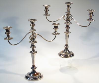 A pair of early 20thC silver plated three branch candelabra