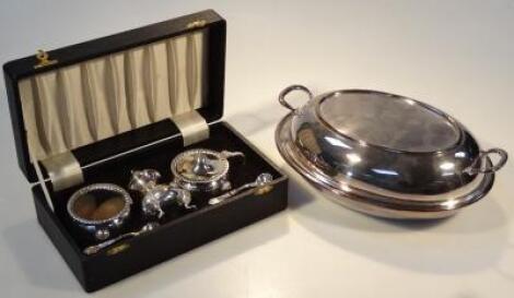 An early 20thC silver plated cased cruet set