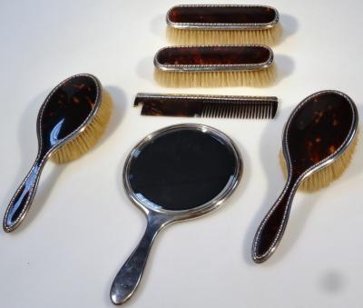 A matched George V six piece and silver tortoiseshell dressing table set