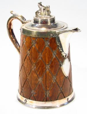 An Edwardian oak and silver plated tankard