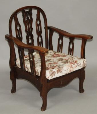 An Edwardian stained walnut adjustable armchair