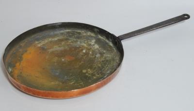 A Victorian copper saucepan cover