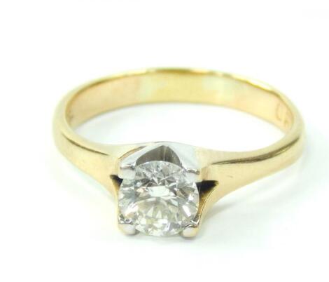 A yellow metal and diamond solitaire ring