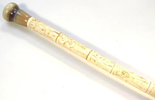 A faux ivory and jade style walking stick