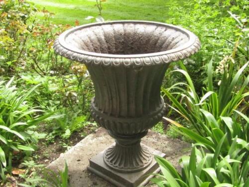 A pair of cast iron campana garden urns