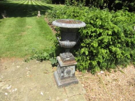 A pair of Victorian cast iron campana garden urns