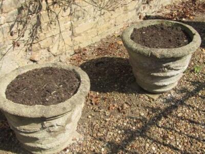 A pair of circular cast concrete planters