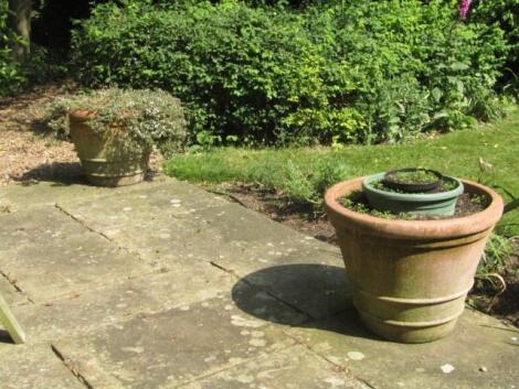 A set of four terracotta garden planters